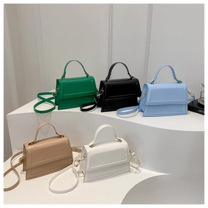 Detailed display of five colorful minimalist square shoulder bags with top handles and straps
