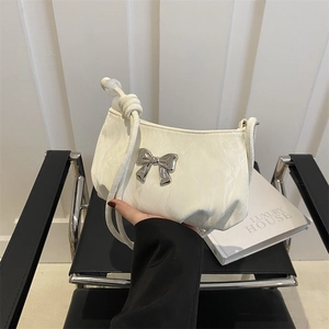 Chic cream ruched underarm bag with silver bow accent and knotted shoulder strap
