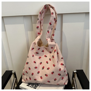 Detailed close-up of pink corduroy tote bag with strawberry prints and soft inner lining