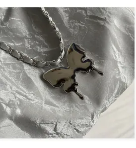 Close-up of polished butterfly pendant with elegant silver leather interwoven chain