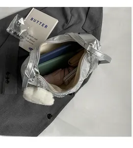 Macro view of silver tote bag interior showing large capacity for umbrella and notebook