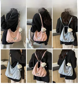 Detailed views of women's nylon tote bag with butterfly charm and plush cloud pendant