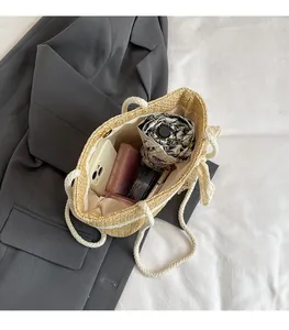 Interior view of beige woven straw tote bag showing spacious capacity for daily essentials
