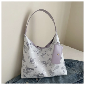 Détail du cabas blanc à imprimé papillon avec bandoulière lilas et petite pochette