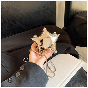 Detailed view of silver Y2K star-shaped mini bag with metallic finish and snake chain
