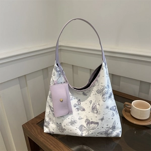 Elegant white tote bag with purple butterfly print and matching small pouch hanging