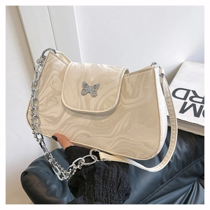 Close-up of marble pattern underarm bag with silver butterfly clasp and chain strap