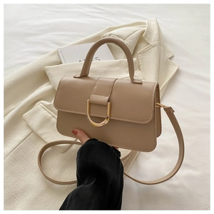 Elegant beige PU leather handbag with gold horseshoe buckle and adjustable shoulder strap