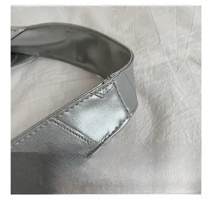 Detailed macro shot of silver metallic leather handles with high-quality stitching