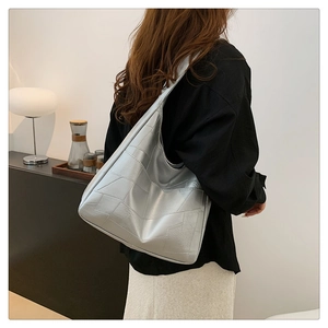 Detail of silver metallic tote bag featuring geometric patchwork design and large capacity