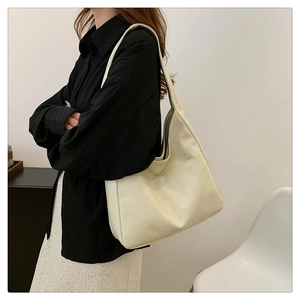Detail of geometric quilted stitching on large off-white minimalist tote bag
