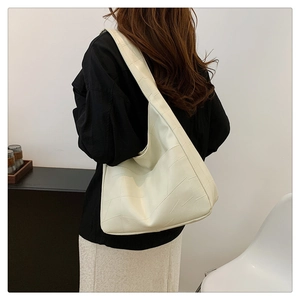 Detail of cream large tote bag with geometric stitching and relaxed Hobo design