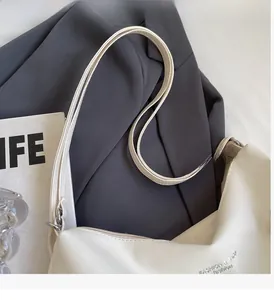Detail view of white PU leather tote showing silver rings and Fashion & Bags text logo