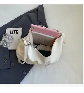 Top view of white leather tote bag interior showing spacious capacity with a tablet