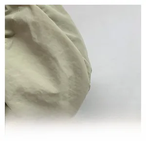 Detailed macro shot of light green pleated fabric texture with neat stitching detail