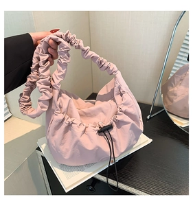 Detail of pink pleated tote bag with a matching scrunchie handle and drawstring closure