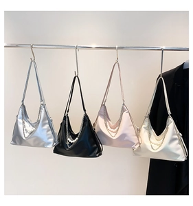 Detail view of stylish crescent bags in silver, black, pink and white with pearl chains