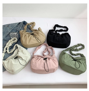 Detailed display of five colorful nylon drawstring cloud bags with pleated textures