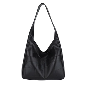 Minimalist black patchwork leather tote bag with a spacious interior for commuting