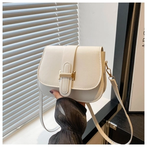 Close-up of white semi-circle crossbody bag with gold metal hardware buckle and strap
