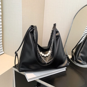 Fashionable black faux leather hobo bag with silver chain and white pearl accents