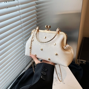 Elegant cream shell bag with golden heart studs and vintage metal handle for women