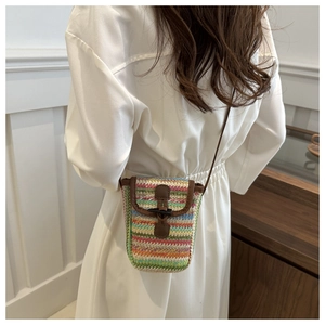Detailed back view of a colorful woven mini crossbody bag with leather horn buckle strap