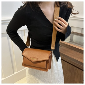 Close-up of caramel crossbody bag with Fashion & Bags logo and wide fabric strap