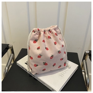 Detail of pink corduroy mini bucket bag with cute strawberry print and white drawstring