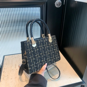 Chic black tweed plaid handbag with golden thread accents and round woven handle