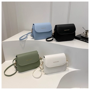 Minimalist square crossbody bags in four solid colors displayed on a white step background