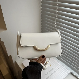 Chic beige crossbody bag with golden crescent clasp and slender shoulder strap