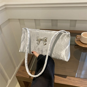 Silver bow bucket bag in pleated metallic fabric with slim shoulder strap for women