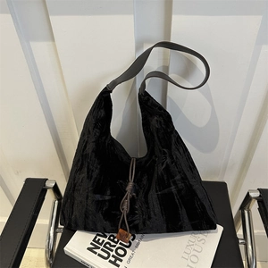New Chinese style large black crushed velvet tote bag with brown leather strap on a chair