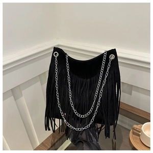 Close-up of black suede tote bag featuring long fringes and silver chain straps details