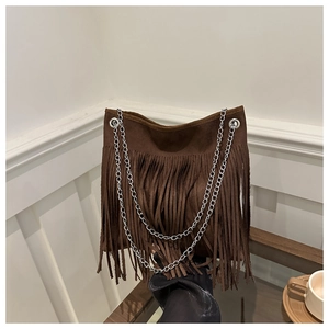 Detail of dark brown suede shoulder bag featuring long fringes and silver metal chain