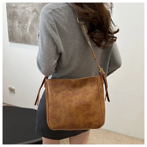 Rear view of vintage brown tote bag showing textured leather and wide shoulder strap