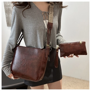 Detail of vintage brown tote bag with geometric ethnic shoulder strap and small pouch