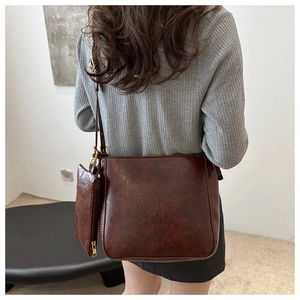 Detail of vintage coffee bucket bag set with wide strap and matching pouch