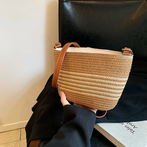 Striped straw bucket bag with brown leather strap for summer beach vacation use