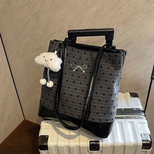 Chic grey polka dot tote bag with black leather base and cute cloud plush charm