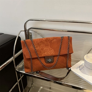 Orange corduroy tote bag with floral print, metal twist lock and chain strap