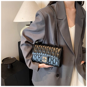Quilted black chain crossbody bag featuring a bicolor floral metal twist lock on the front