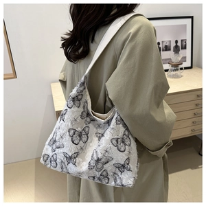 Detail of canvas tote bag showing textured fabric with realistic black butterfly prints