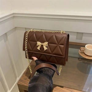 Elegant coffee brown quilted crossbody bag with gold bow lock and metal chain strap