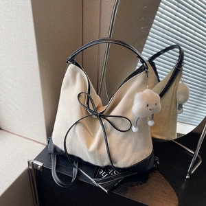 Minimalist beige canvas hobo bag with black leather trim and cute cloud plush charm