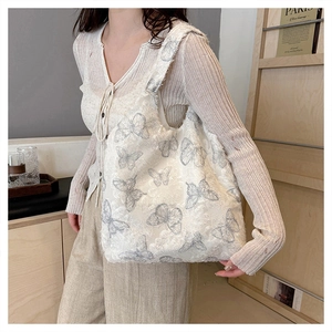 Close-up of exquisite butterfly lace embroidery on white canvas tote bag for women