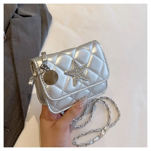 Close-up of silver quilted crossbody bag with rhinestone star and chain strap detail