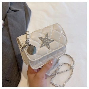 Detail of a beige quilted mini bag with a rhinestone star and silver chain strap