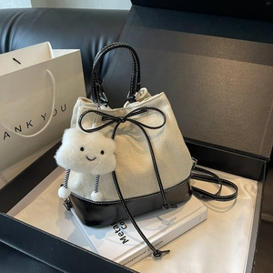 Fashionable beige drawstring bucket bag with black leather trim and cute cloud charm